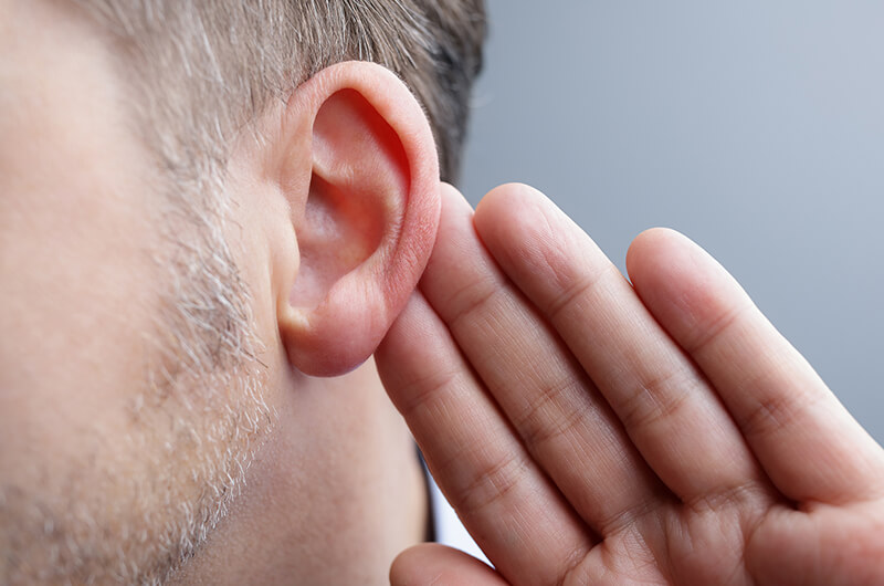 Man-with-hand-on-ear-listening